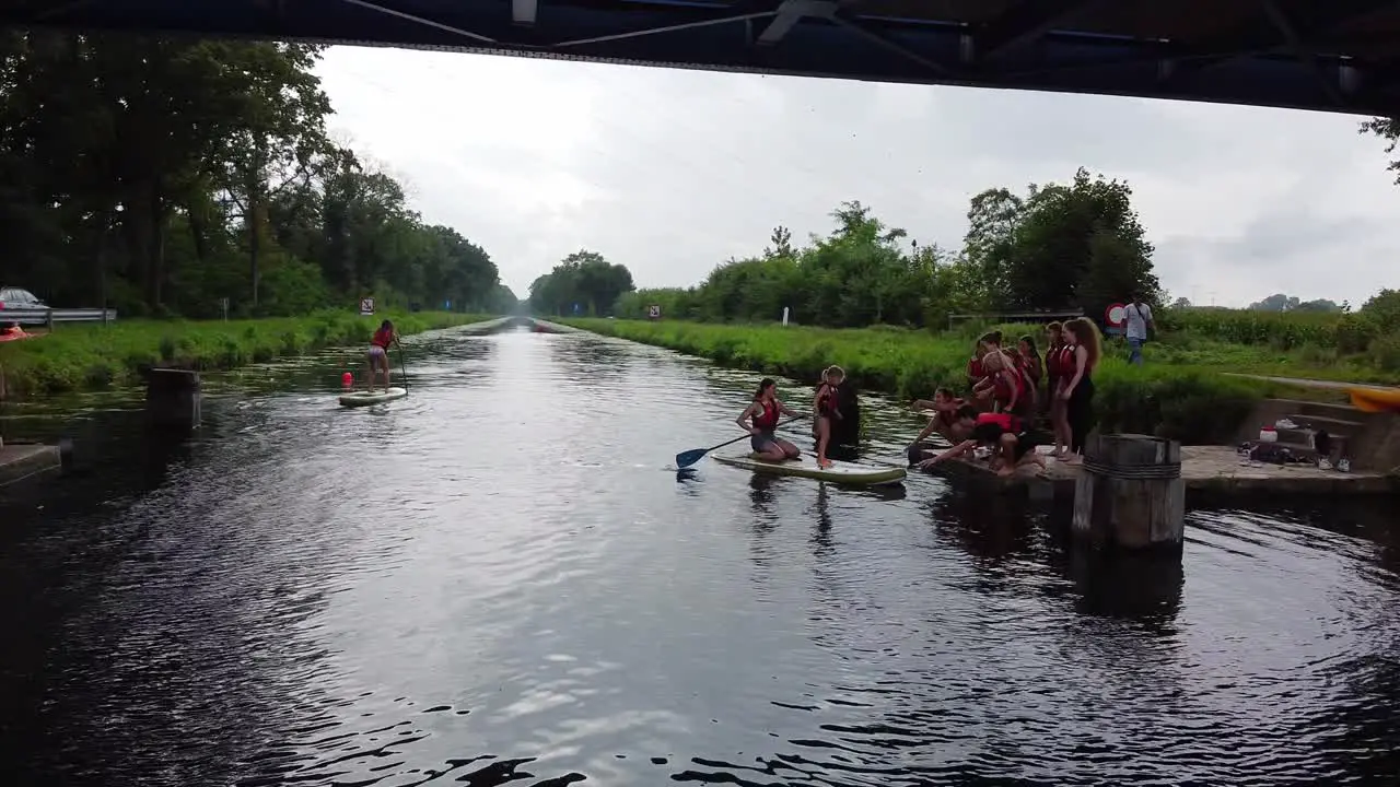 Teambuilding sport event supping over the canal with two persons