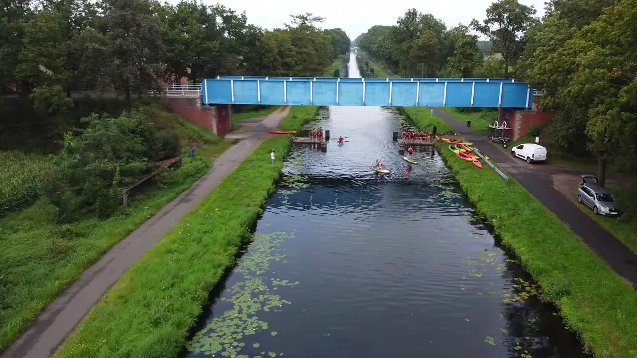 Sport event under a bridge with kayaks and sups on the Beverlo canal