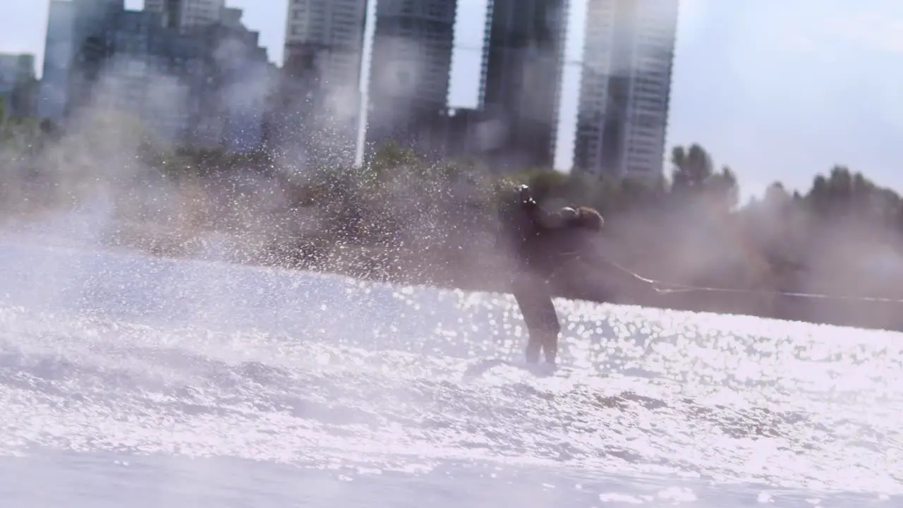 Athlete riding wake board