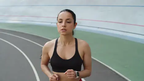 Runner woman jogging on sport track at stadium Sport woman running