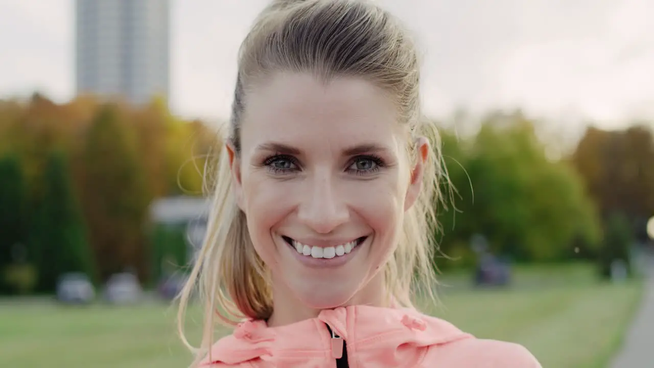 Handheld view of smiling young woman looking at camera