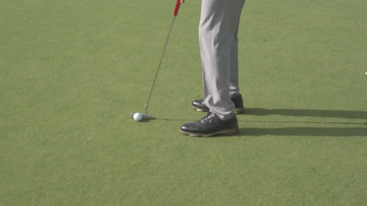 close-up scene in which an Indian young golfer hits a stunning short shot on a golf course