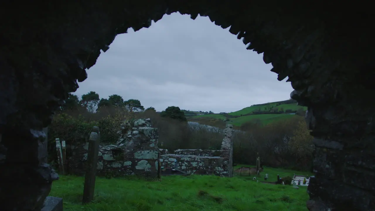 Arch Ruin Of An Old Stone Church With Graves Ireland