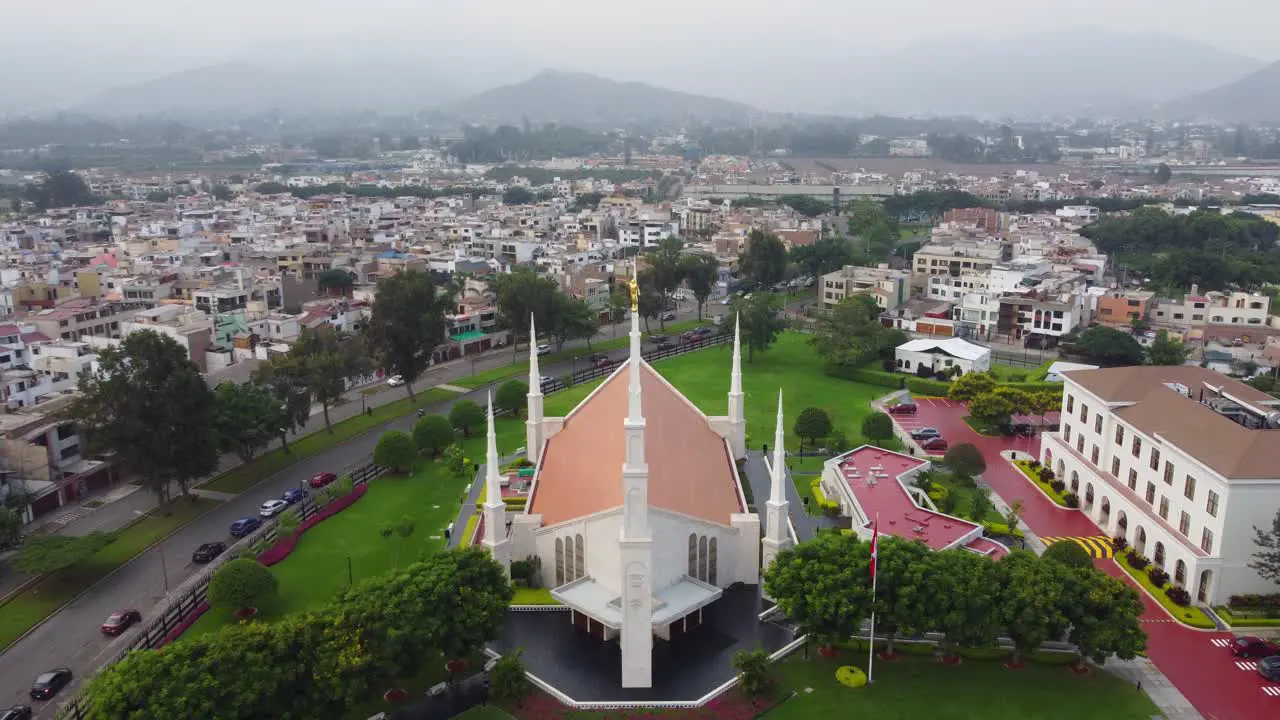 Drone video of a mormon church with a golden statue of the angel moroni