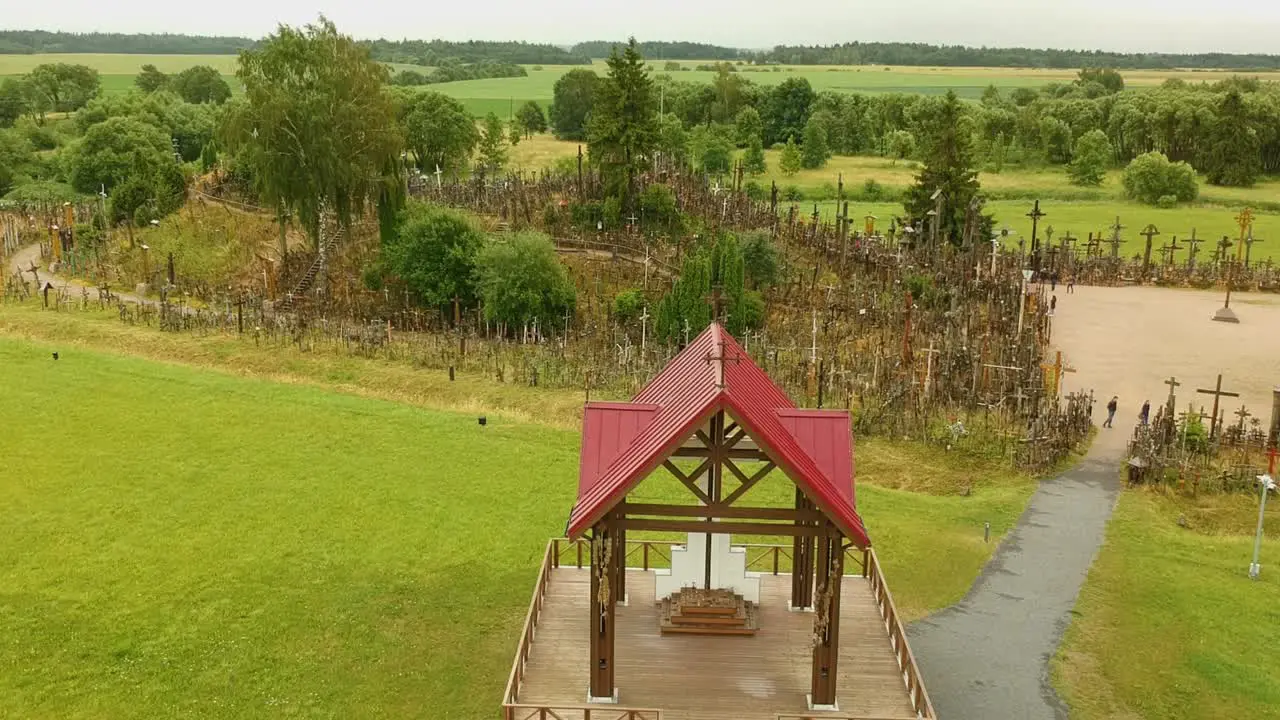 An aerial shot ascending over the Hill of Crosses Lithuania