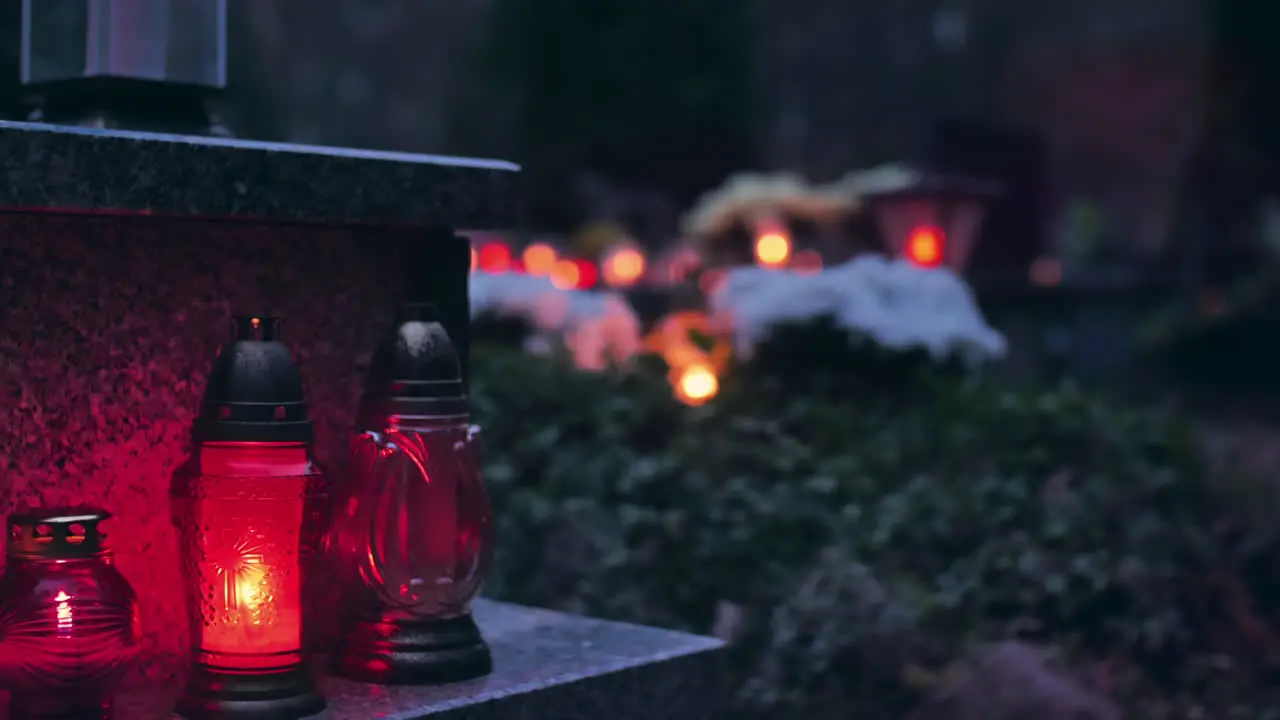 Burning grave candles in a cemetery