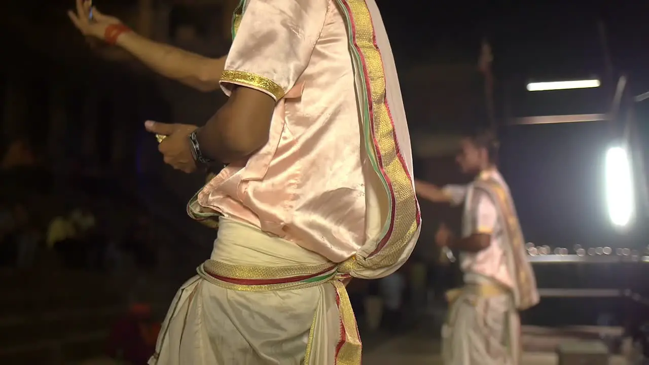 Man Waves Fan and Rings Bell Ceremoniously