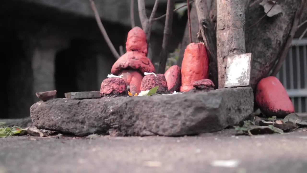 Traditional religious symbols painted orange in an Indian temple