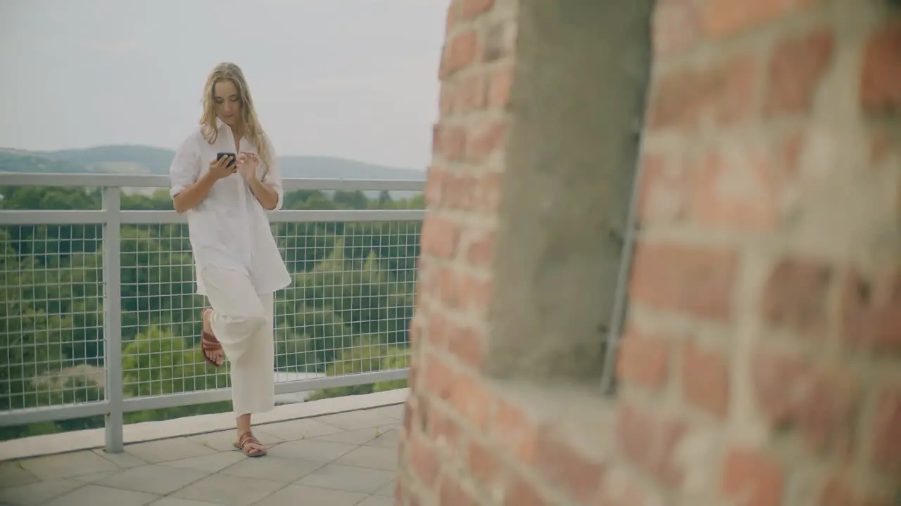 Woman Typing on Smartphone Outdoors