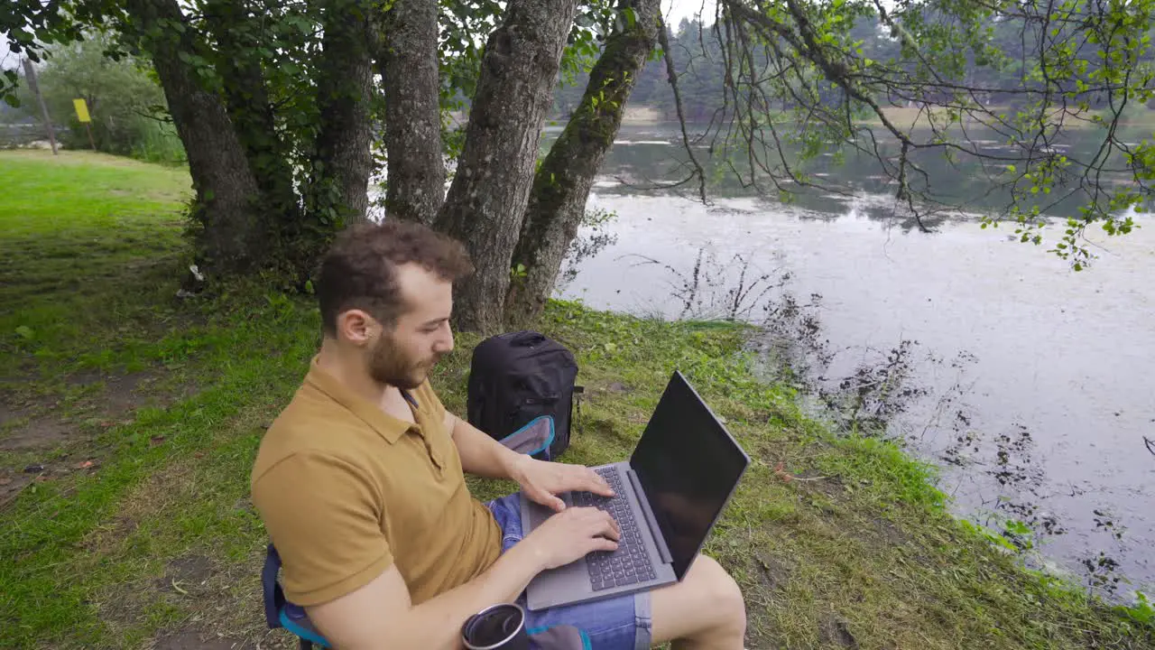 Freelance businessman working on laptop in nature park