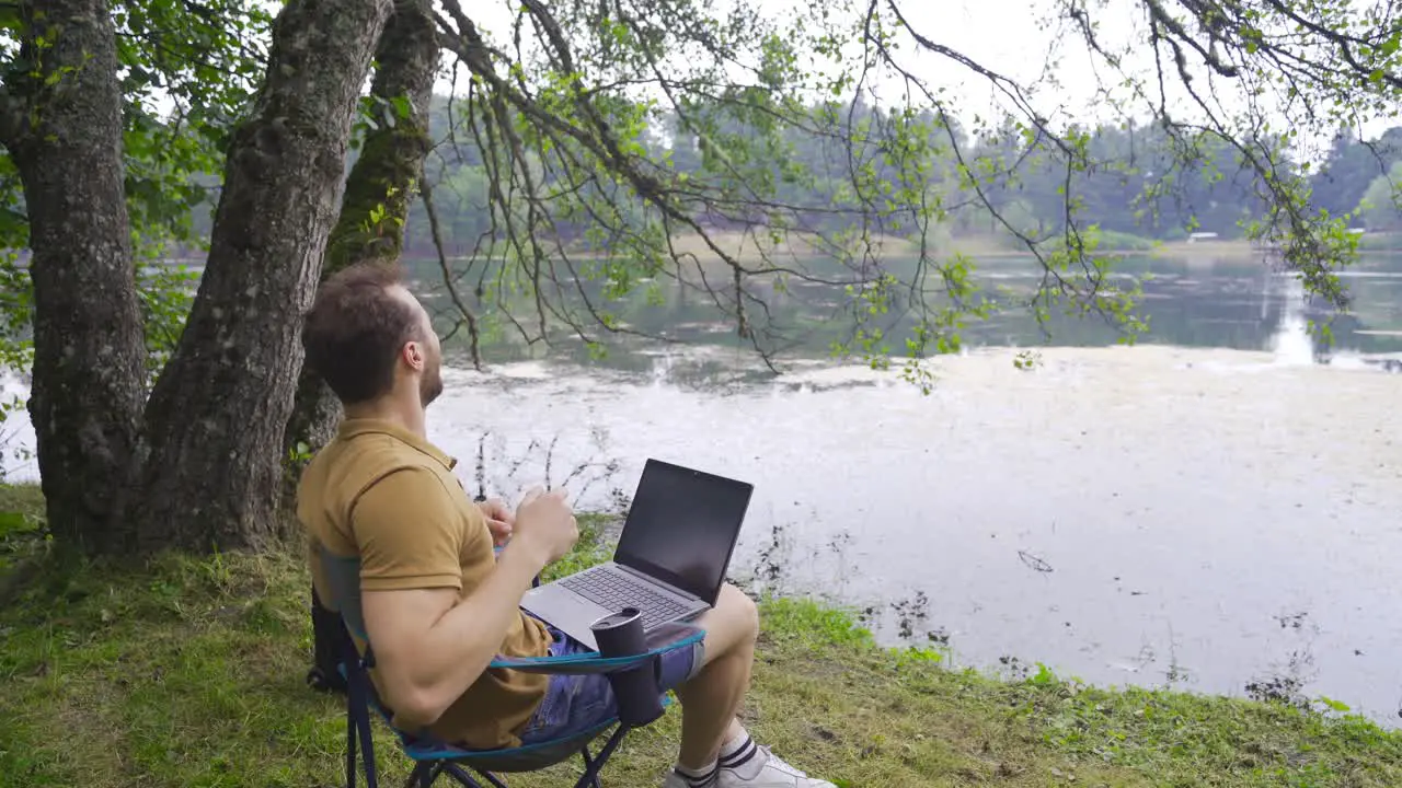 Happy and joyful man working with laptop