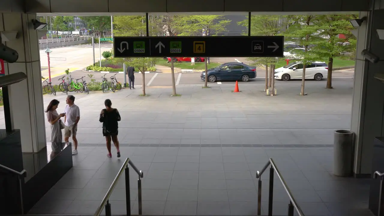 Passengers exit Outram MRT Station in Singapore