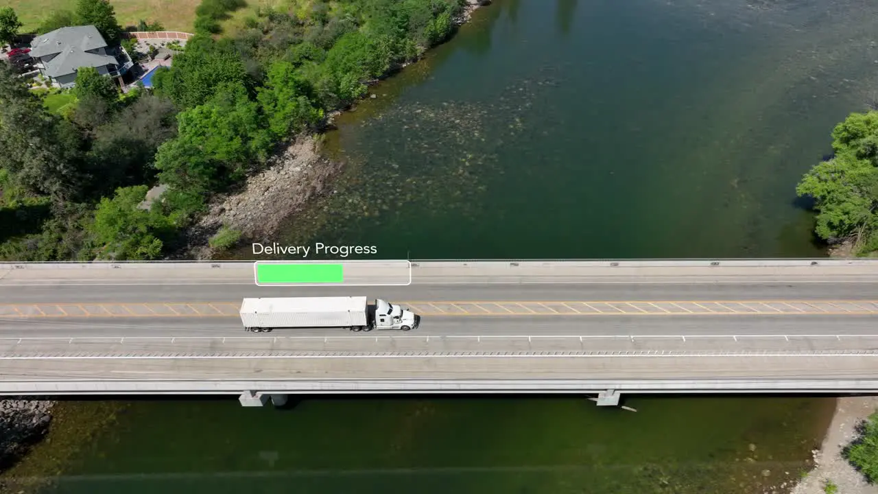 Aerial view of a semi truck crossing a bridge nearing its delivery destination