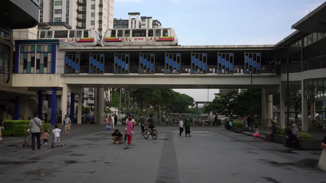 Scene of the LRT train arriving at the station and people commuting outside Bukit Panjang MRT Station  Singapore