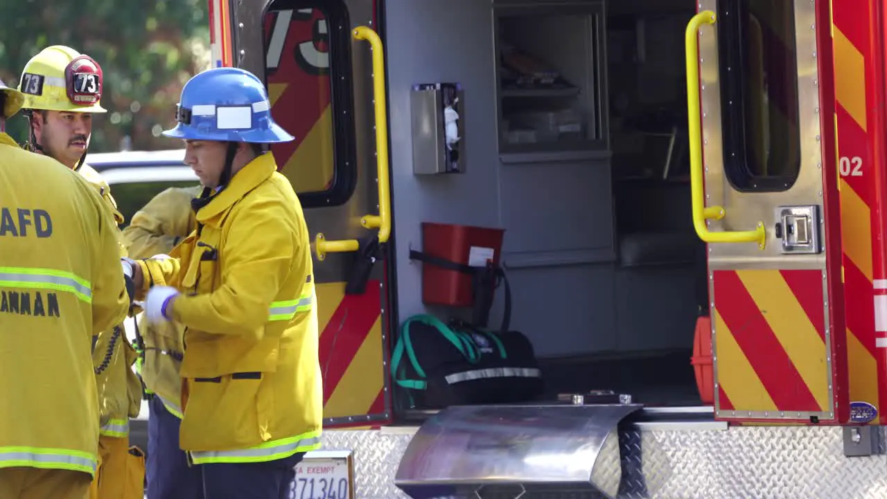 firefighters load patient into ambulance