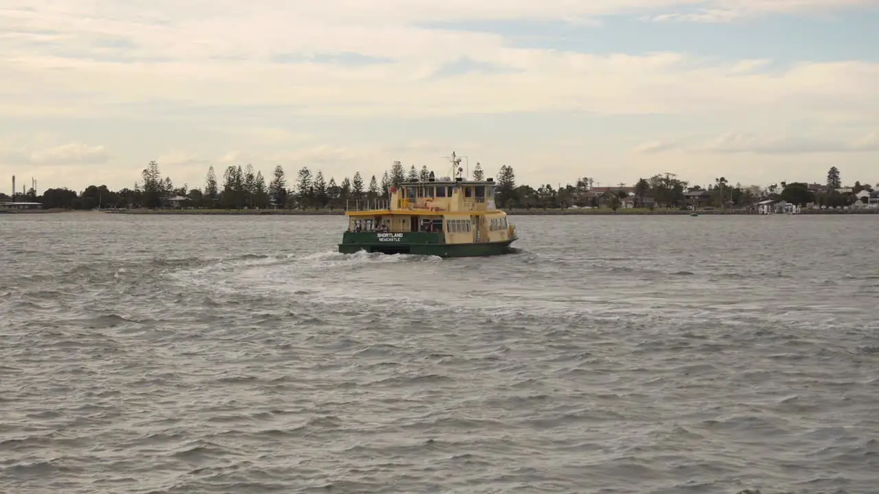 Ferry pulling away on Newcastle harbour at dusk