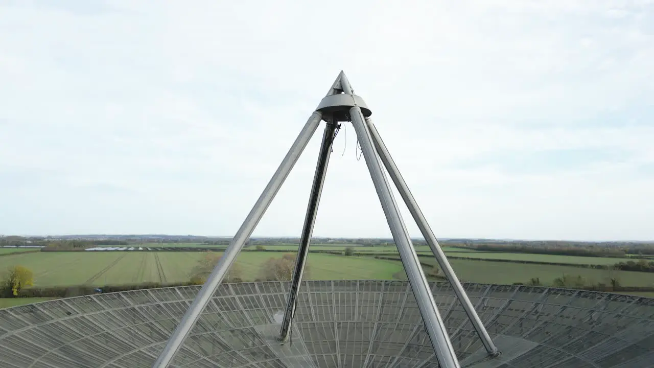 Rising aerial view above MRAO Mullard radio observatory telescope on Cambridge farmland