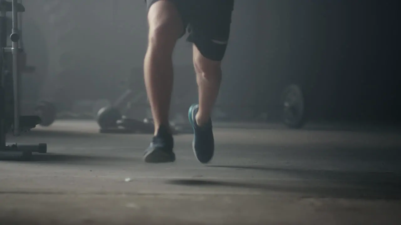 Fitness man standing on start position Male jogger legs running in sport club