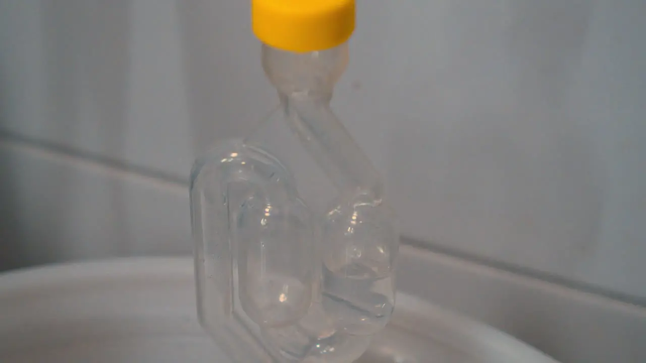 Close-up of a safety tube with boiling clear liquid in a laboratory experiment