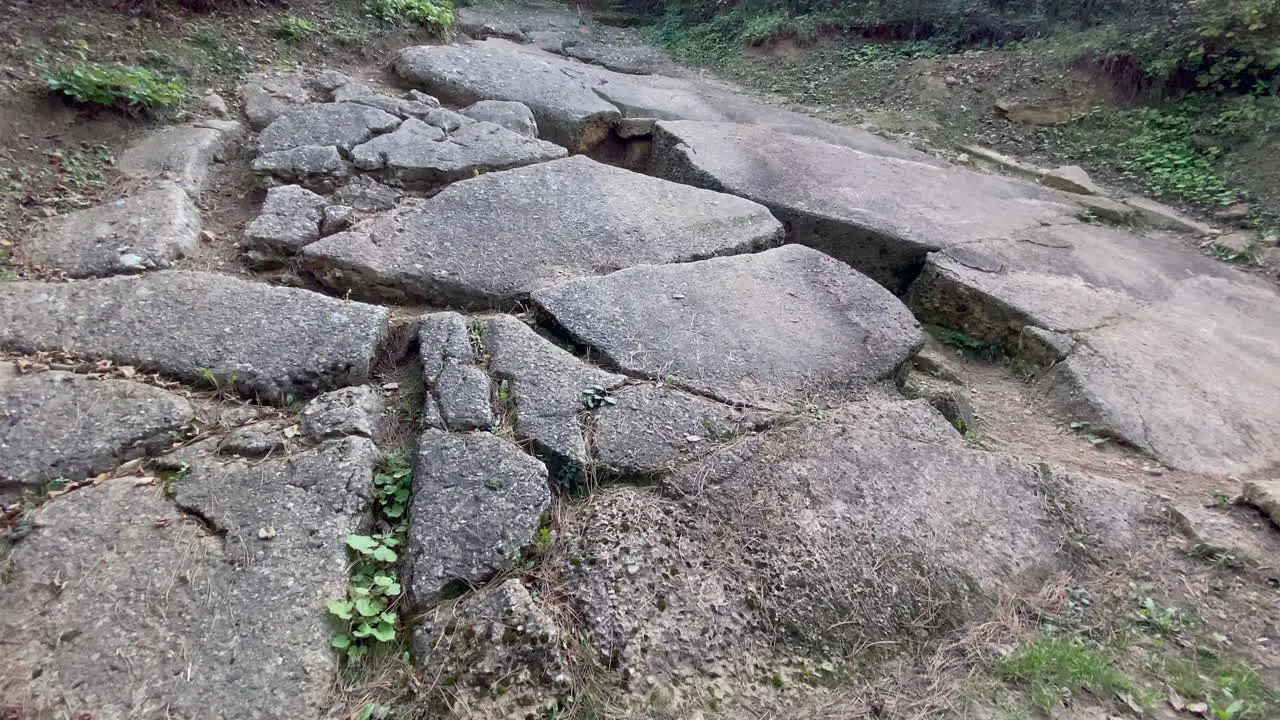 Dolly move shows stones and concrete of excavations at the pyramid of sun an ancient building in the Bosnian tale of the pyramids