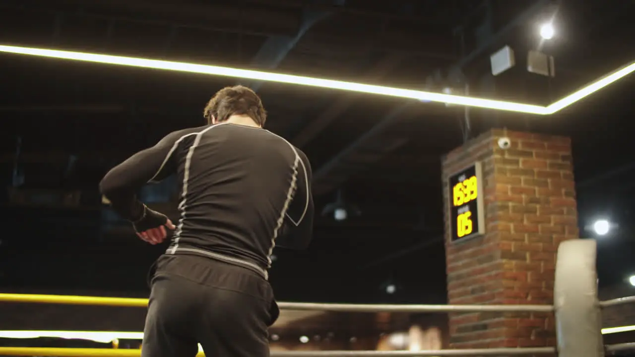 Young sport man warming up at gym Male boxer doing punches on boxing ring