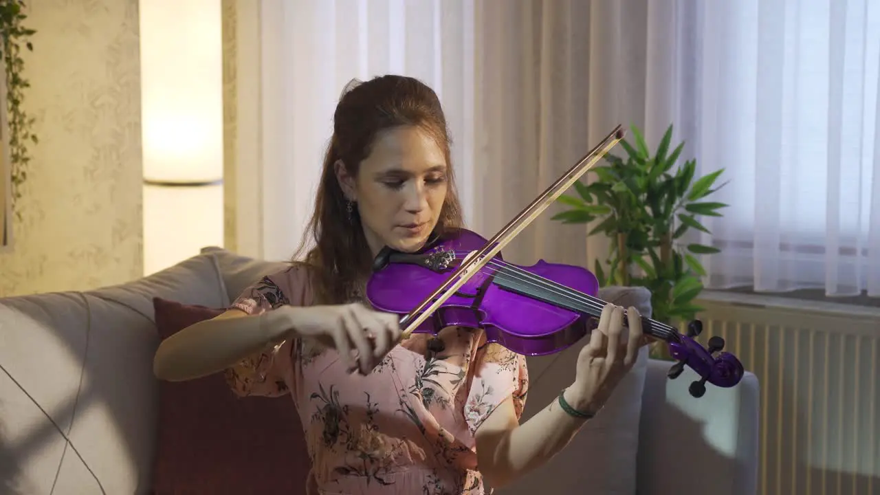 Musician woman playing violin alone at home Music and sheet music