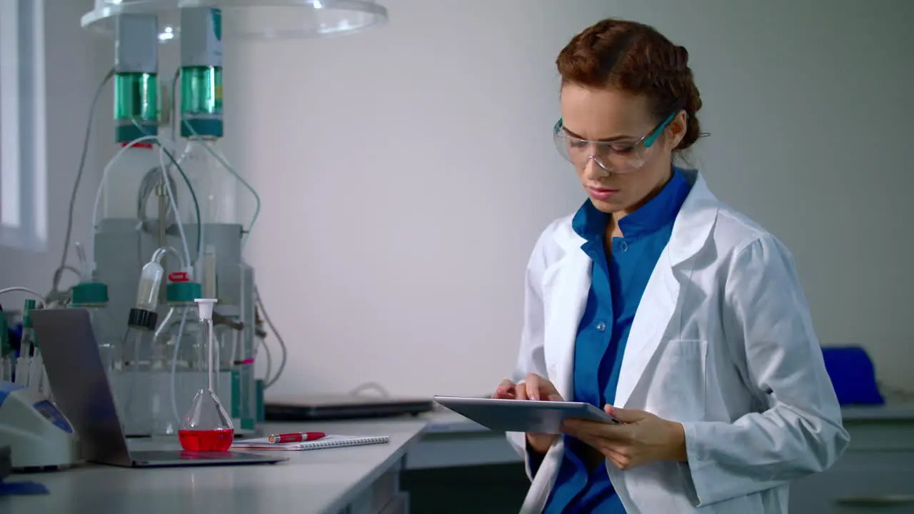 Female scientist working with scientist tablet Researcher working in lab