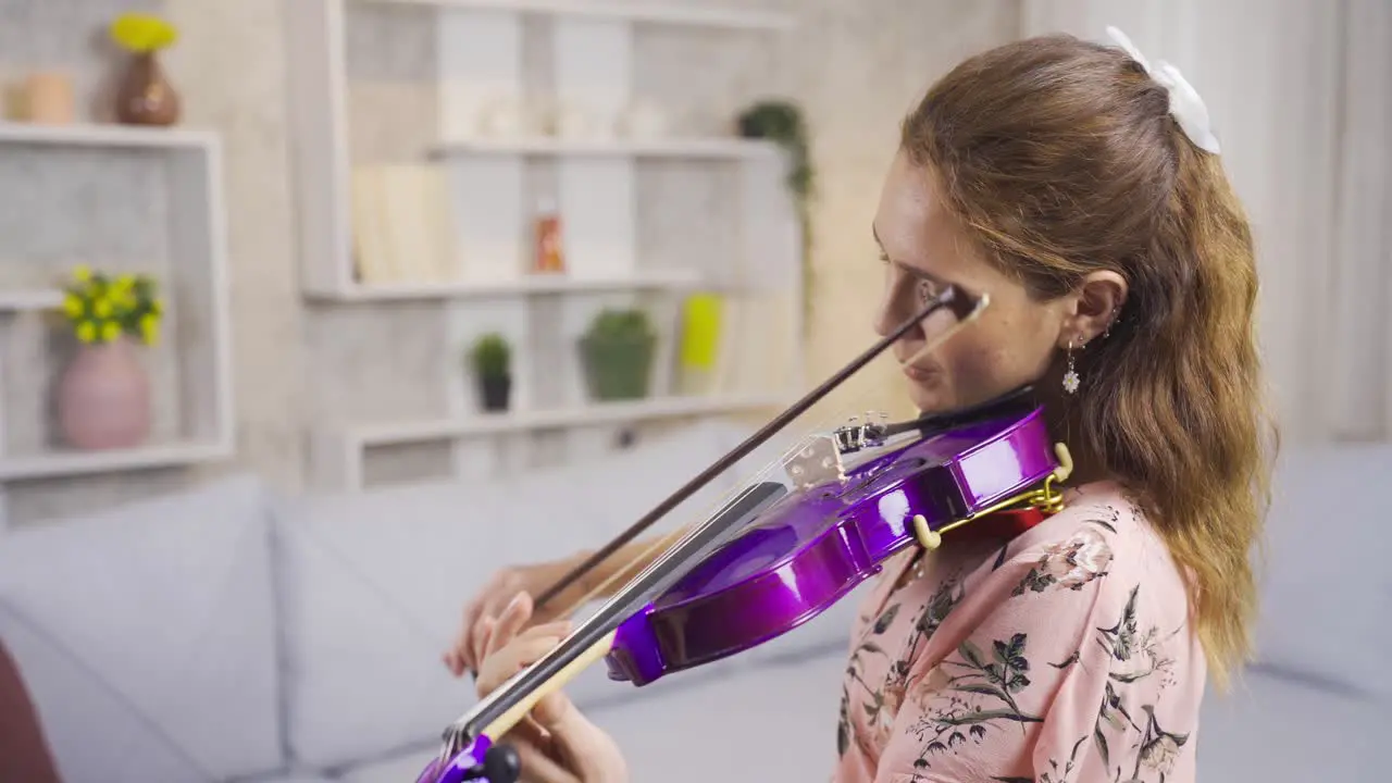 Inspiring elegant woman playing violin