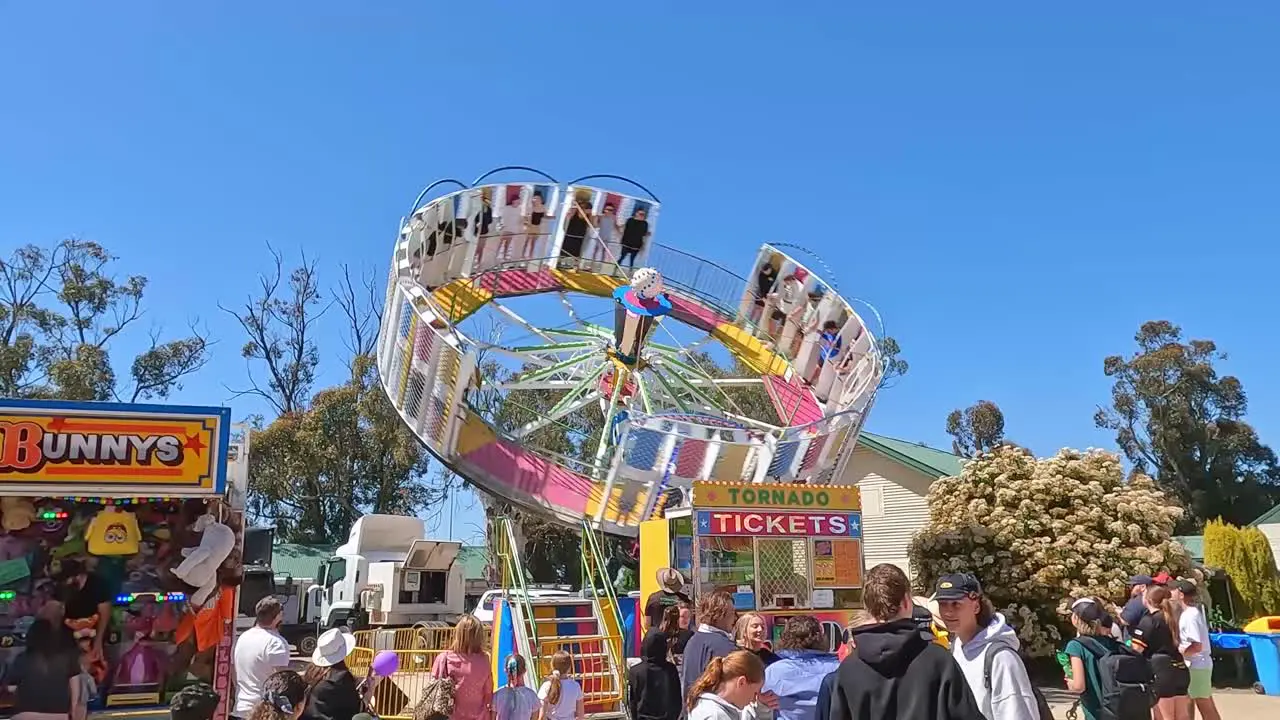 Yarrawonga Victoria Australia 7 October 2023 View of people watching others riding on the spinning Tornado ride at the Yarrawonga Show in Victoria Australia