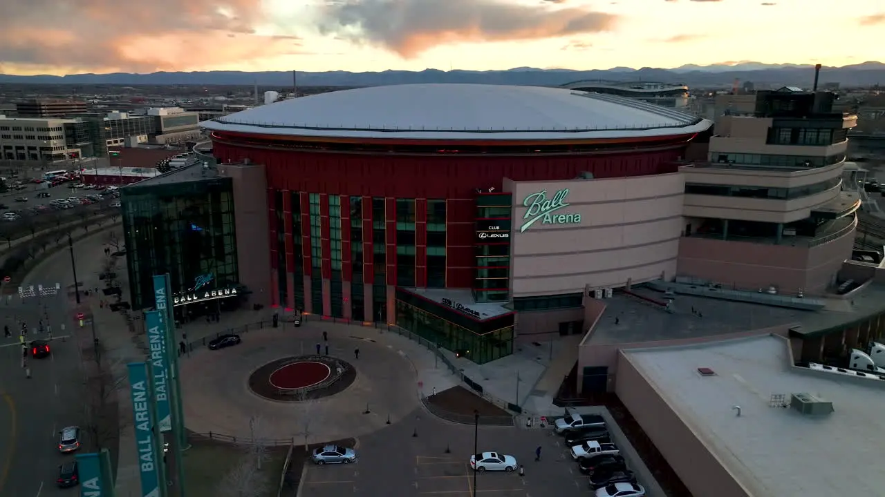 Vivid sunset sky over iconic Ball Arena in Denver Colorado aerial view