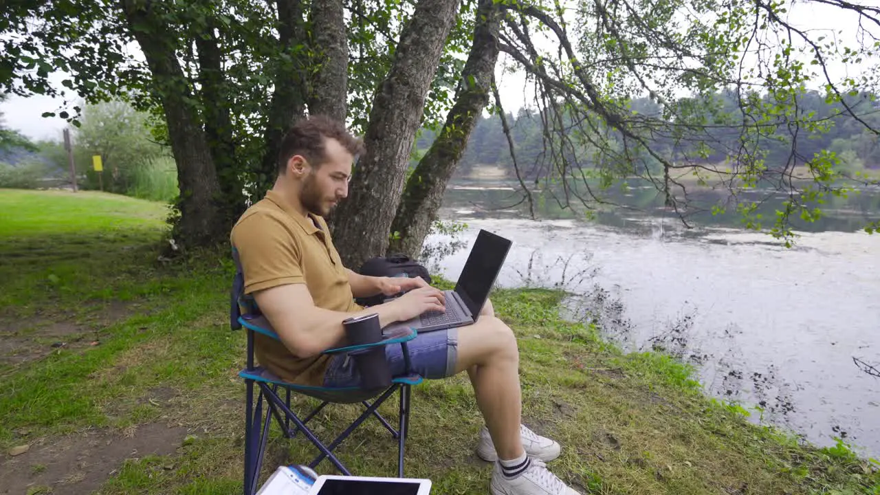 Working with computer by the lake