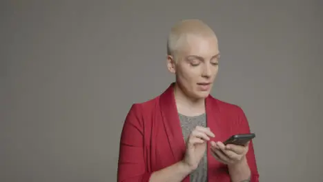 Female model posing with smartphone during studio portrait 01