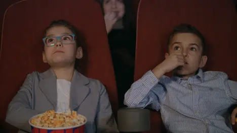 Young spectators watching movie at cinema Movie children entertainment