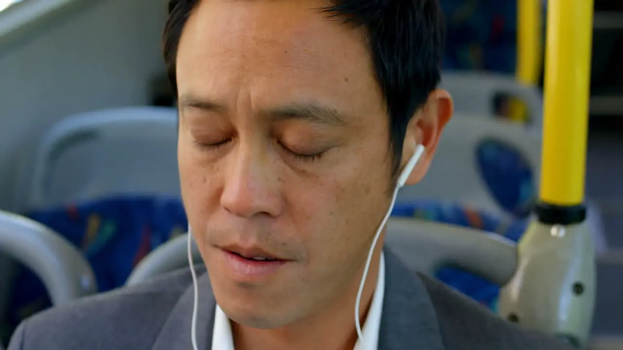 Male commuter listening music while travelling in bus 4k