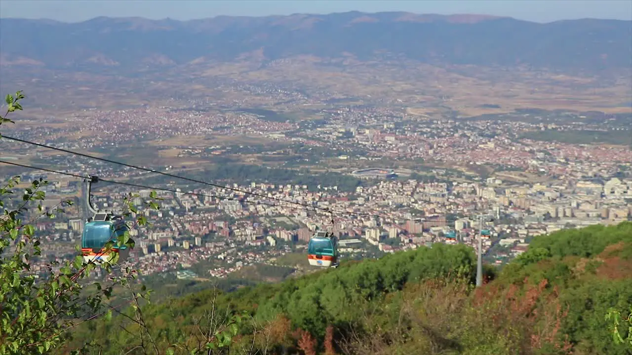 Cityscape of an urban town and a cableway spreading from bottom to the top