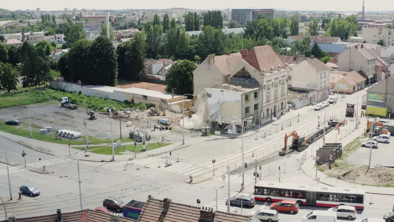 Demolition of ruined house at busy city junction with traffic in Brno