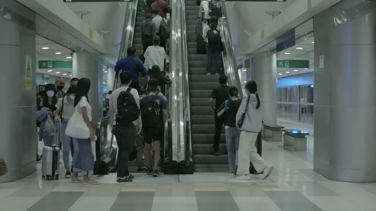 arrive at subway metro train station in airport using escalator