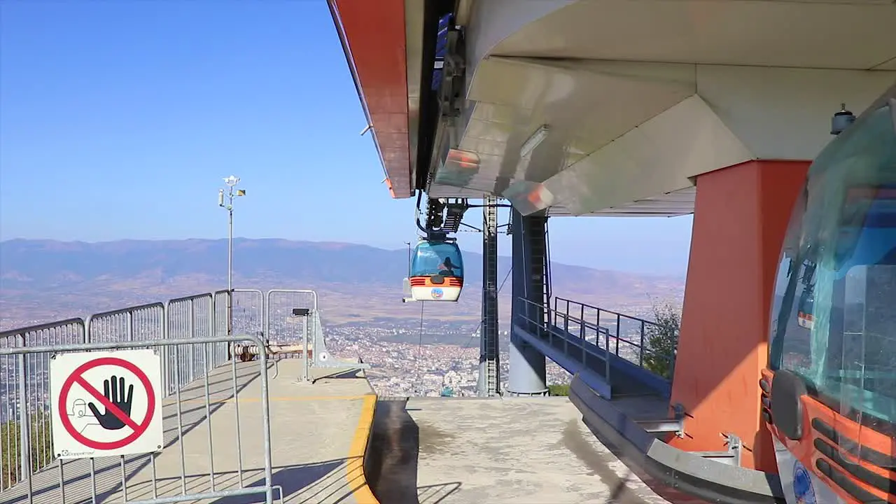 Cable car starts its journey from the highest point of the hill with panoramic view of the city