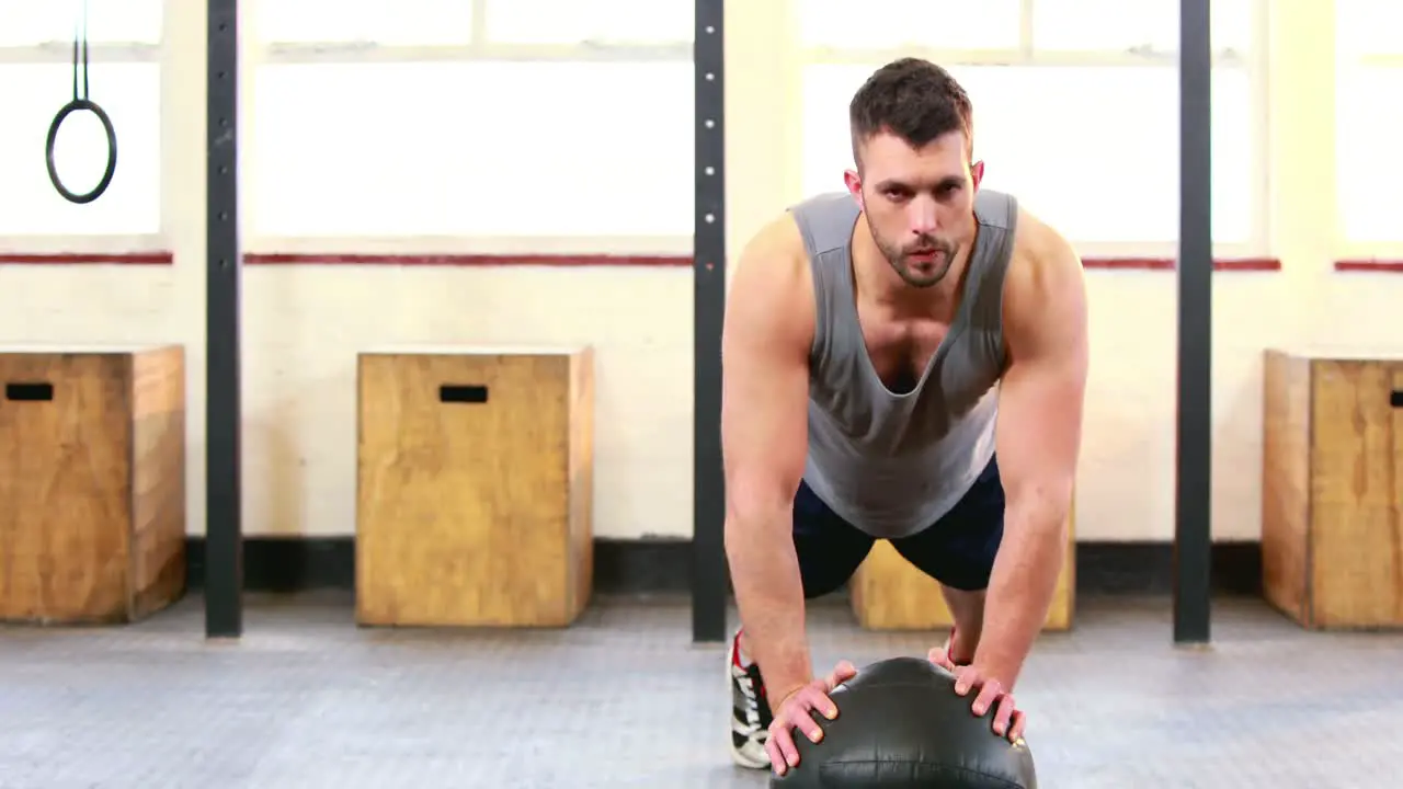 Fit man doing push ups in crossfit studio