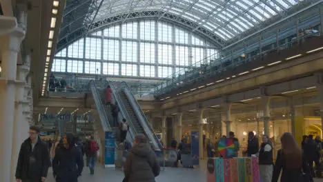 Escalators And Concourse At St Pancras Rail Station In London UK With Commuters