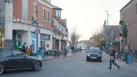 Shops On Putney High Street London Decorated For Christmas Busy With Shoppers And Traffic