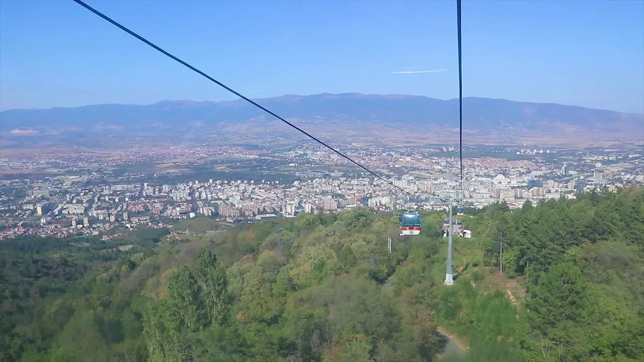 Moving aerial shot from a cable car with more elevator cars going up and down