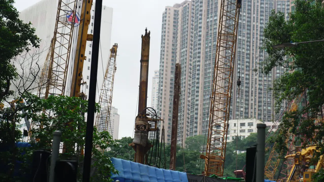 Moving construction site shot from below with Hong Kong skyscrapers in the background