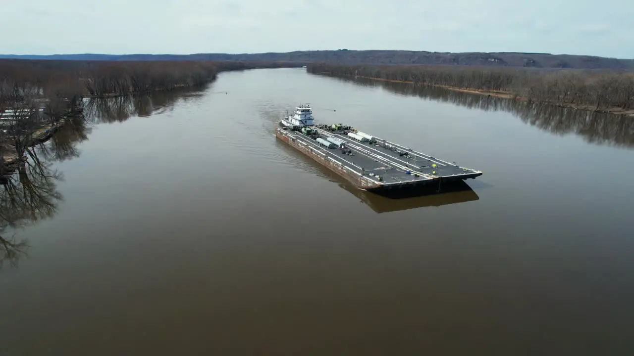 A towboat pushes fuel barges north on the Mississippi River