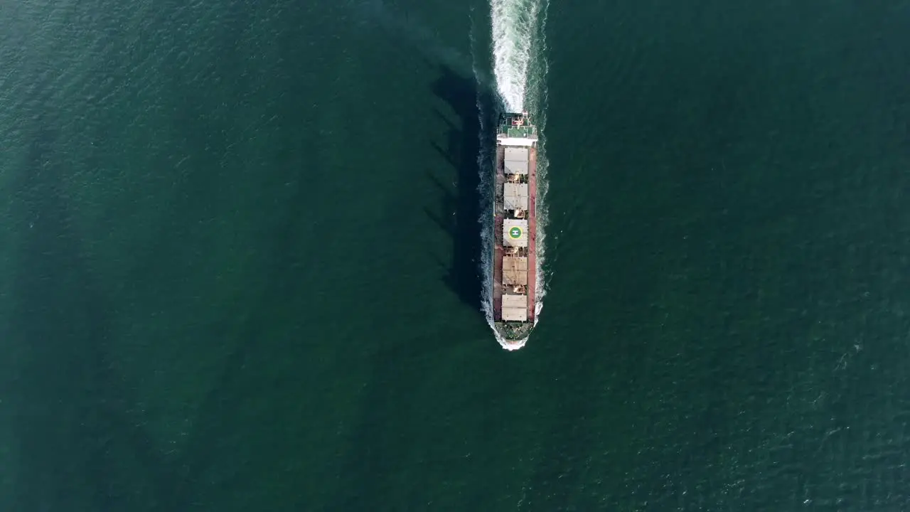 Top down aerial footage of a Cargo ship cruising in Hong Kong bay