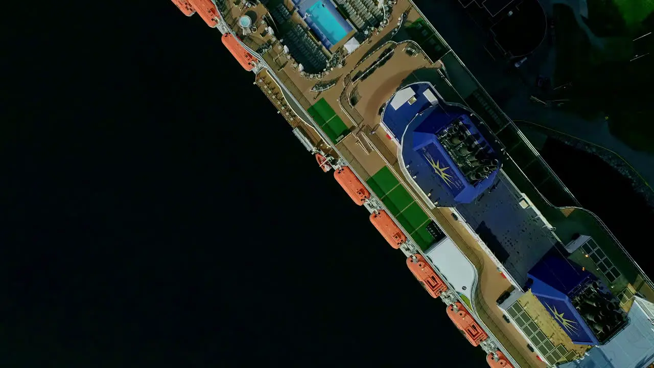 Aerial topdown view of docked cruise ship top deck flyover