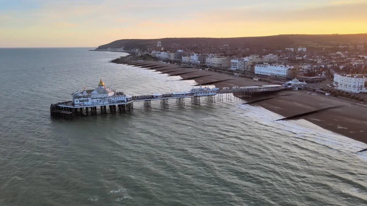 Eastbourne Pier and town at Sunset Sussex Uk Aerial pull back reveal view 4K