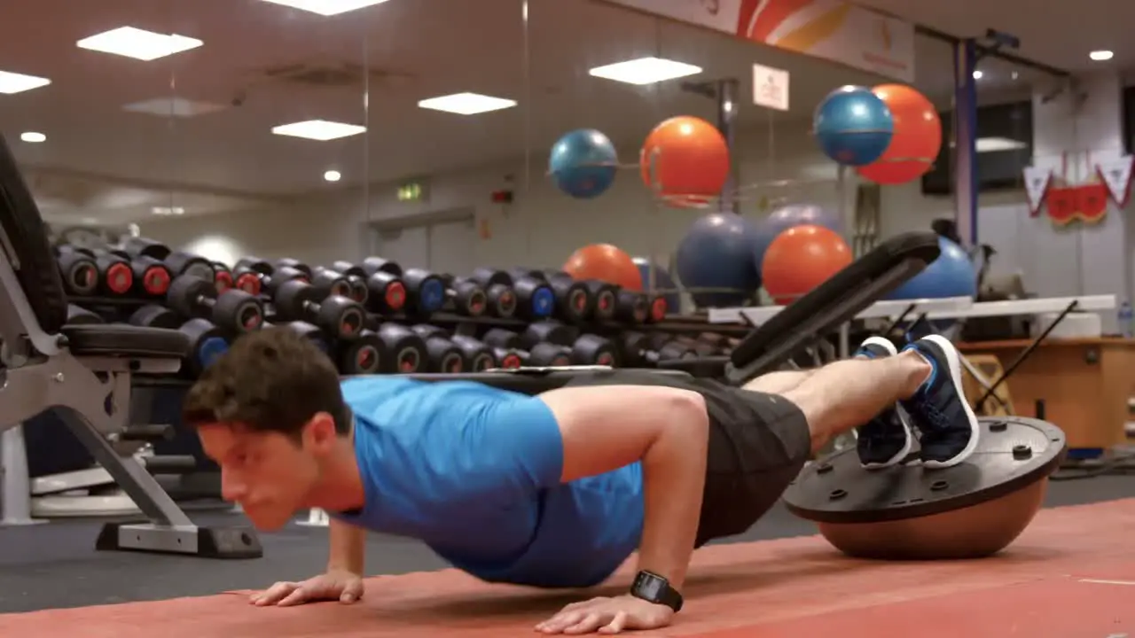 Man doing push ups on bosu ball