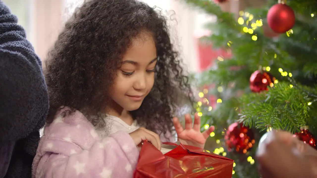 MCU of Child Opening Christmas Present