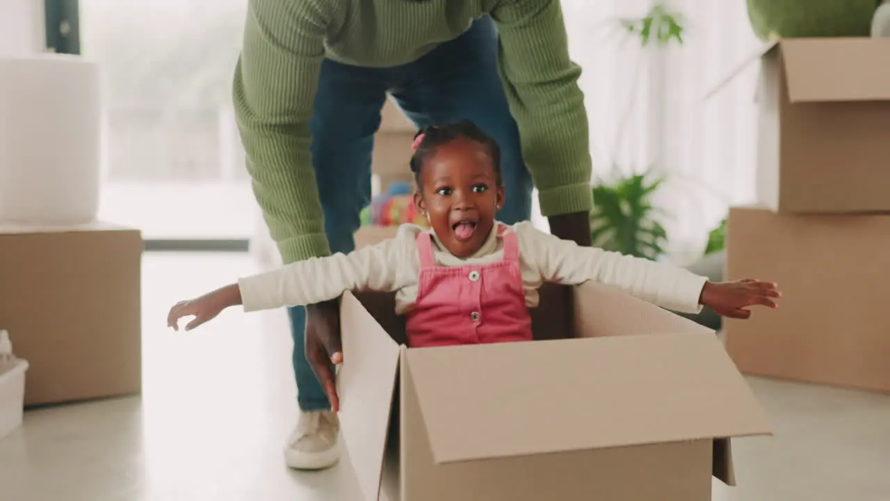 Child father and pushing box in new house